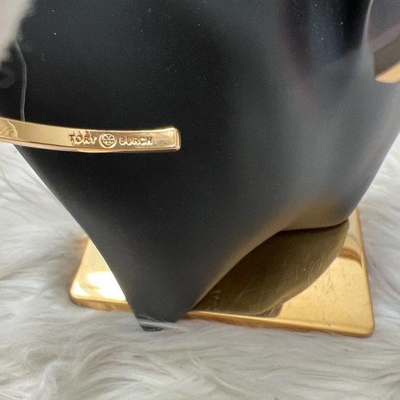 Tory Burch Elegant Gold Cross Bangle with White Enamel Design - Picture 7 of 10